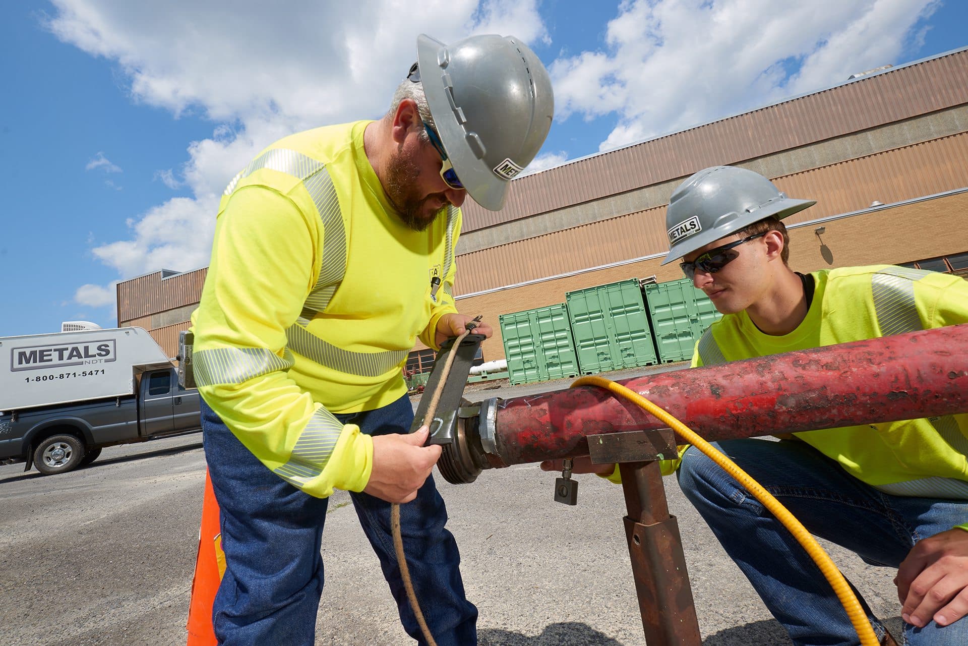 Two workers at metals testing service starting measurements